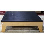 Italian Moderne style occasional table, having a square black quartz top, above a blondewood