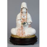 Japanese porcelain Benzaiten, Buddhist goddess of wisdom, seated holding a scroll, wearing white