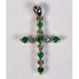 Emerald, diamond and 18k white gold cross pendant Featuring (6) round-cut emeralds, weighing a total