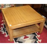 Mid-century modern coffee table, of square form and rising on square legs conjoined by a lower tier,