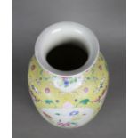 Chinese enameled porcelain vase, with a short trumpet neck above an ovoid body featuring reserves of