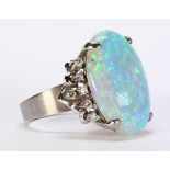 Opal, diamond and 10k white gold ring Featuring (1) oval opal cabochon, measuring approximately 23 X