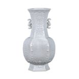 Chinese blanc de chine porcelain vase, of hexagonal section, molded with panels of stylized lotus,