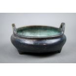 Chinese copper alloy censer, the compressed body with handles raised on three supports, base marked,