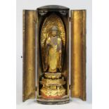 Japanese zushi traveling shrine, gilt wooden Buddha standing on dais, black wooden case with gilt