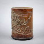 Chinese bamboo brush pot, of cylindrical form carved with figures on a boat enjoying the landscape