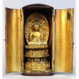 Japanese zushi traveling shrine, gilt wooden Buddha seated on dais, black lacquered case with gilt