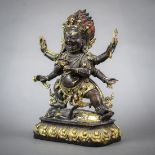 Sino-Tibetan bronze figure, Mahakala, the wrathful deity holding a ritual chopper and skull cup in