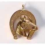 18k yellow gold horseshoe pendant Designed as a horse head in a horseshoe, measuring approximately