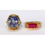 (Lot of 2) Synthetic corundum and 18k gold rings Including 1) oval synthetic blue sapphire (