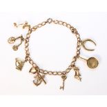 Yellow gold charm bracelet The 10k yellow gold, open link, 4.0 mm chain, suspends (8) charms,