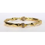 18k yellow gold bracelet The 18k yellow gold, hollow twist motif, hinged bangle, measures