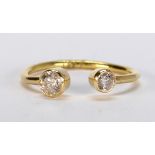 Diamond and 18k yellow gold ring Featuring (2) round-cut diamonds, weighing a total of approximately