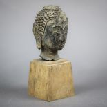 Thai small bronze Buddha head, stylized with the aquiline nose and downcast eyes, with an archaic