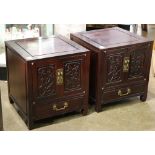 Pair of Chinese wooden side tables, each fronted by hinged doors carved with birds and flowers,