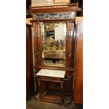 Victorian Eastlake hall tree, having a galleried top, above the centered beveled mirror, flanked