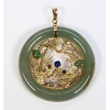 Multi-stone and 14k yellow gold pendant Featuring (1) jadeite 7.5 mm wide ring (damaged),