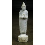 Southeast Asian marble sculpture of the Buddha, with both hands near the chest forming the manidhara