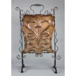 Art Nouveau copper and iron fireplace screen, having scrolled supports, surrounding a copper panel