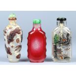 (lot of 3) Chinese glass snuff bottles: one of red overlay, with a flattened body and indented sides