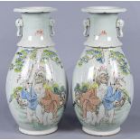 Pair of Chinese enameled porcelain vases, each with an everted foliate rim and elephant handles,