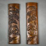 Pair of Chinese bamboo brush rests, one with a herder boy on the back of an ox; the other of two