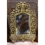 Bradley and Hubbard Rococo style gilt metal wall mirror, the back plate surmounted by the Bacchus