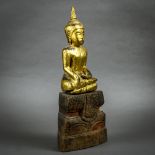 Southeast Asian gilt wood Buddha, seated in bhumispharsha mudra, on a tiered splayed pedestal, 13.
