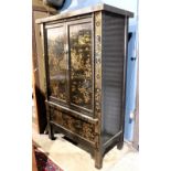 Chinese gilt lacquered armoire, the hinged double doors featuring figures and landscape heightened