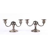 Pair of Stowell weighted sterling silver candlesticks, the three-light fixture with serpentine