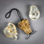 (lot of 3) Chinese rock crystal toggles, of archaistic form, including a pig-dragon and a plaque