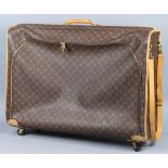 Louis Vuitton soft shell suitcase, having brown canvas monogram, with a zipper on front, and