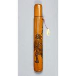 Japanese boxwood pipecase, carved with a peddler carrying a pole with the merchandise, signed [