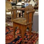 Middle Eastern inlaid armchair, having a stepped form crest, the arms over turned spindles and