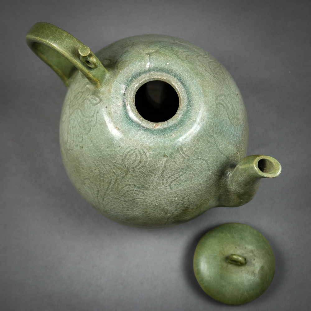 Korean celadon glazed ceramic teapot, the body of peach form incised with floral sprigs, topped by a - Image 5 of 6