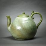 Korean celadon glazed ceramic teapot, the body of peach form incised with floral sprigs, topped by a