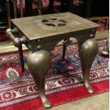 Brass footed mantle stool, 19th Century, the seat with a star motif, and rising on a footed base,
