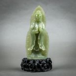 Chinese jade sculpture, of Guanyin holding an amphora, and standing on a lotus pedestal, backed by a