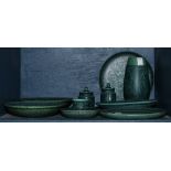 One bin of Ceramica de Taxco Tissot dishes, each with a speckled green and blue glaze, consisting of