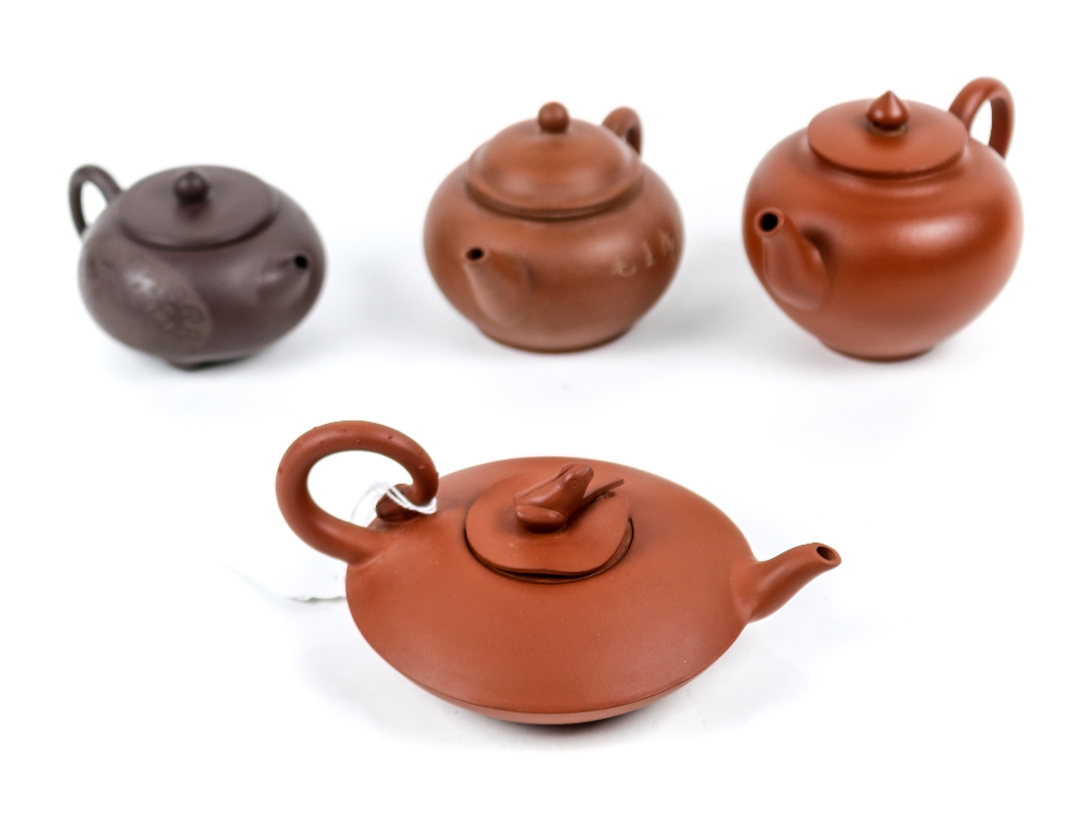 (lot of 4) Chinese zisha ceramic teapots: one with reserve of bat and coins, raised on three short