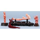 (lot of 3) Chinese coral carvings: the first, of a boy holding a parrot; the second, a standing