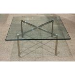 Italian Moderne style occasional table, having a plate glass top with beveled edges, above a