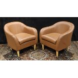 Pair of contemporary leather lounge chairs, each having a curved back continuing to the arms, and