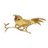 Ruby and 18k yellow gold bird brooch Designed as a bird on a branch, measuring approximately 63 X 50