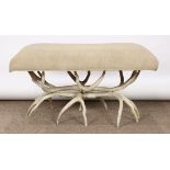 Arthur Court Designs bench, having a taupe upholstered seat, above antler form supports, 19"h x 34.