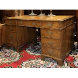 Baker Georgian style writing desk, the rectangular top having a tooled leather writing area over a