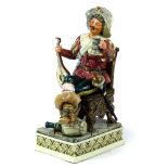 Royal Dux porcelain figural sculpture, "Jolly Cavalier", modeled as a seated male, in cavalier