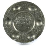 Judaic pewter Passover Seder plate, of circular form with six wells framing the central scenic