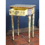 Custom hand painted side table, having a checker board top above the floral decorated single