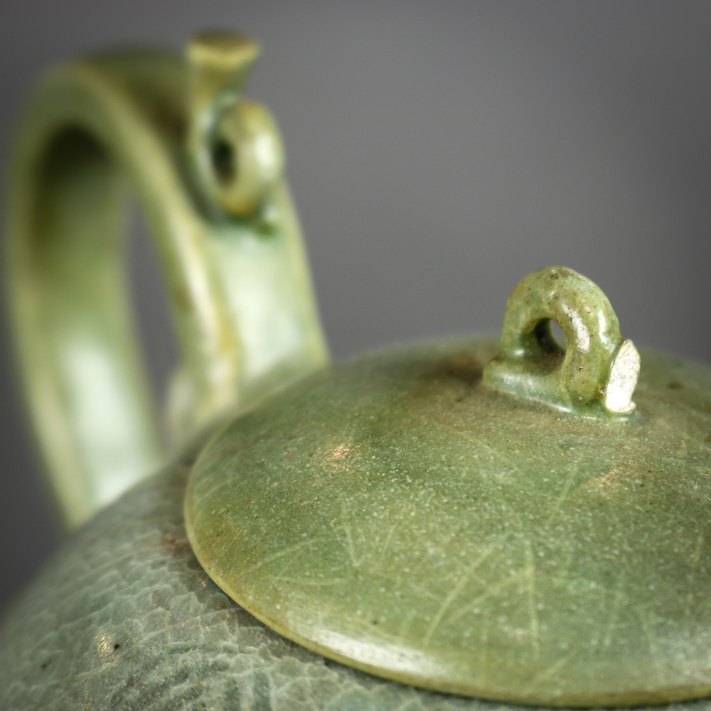 Korean celadon glazed ceramic teapot, the body of peach form incised with floral sprigs, topped by a - Image 4 of 6